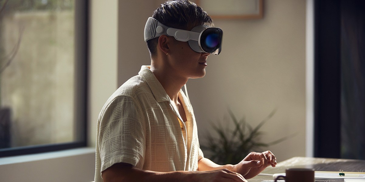 Person using Apple Vision Pro with computer