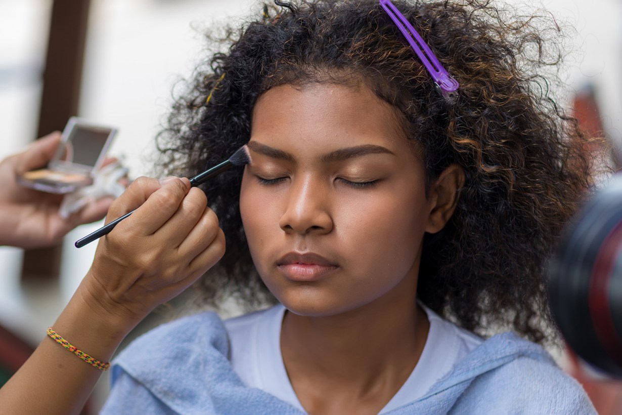 a woman putting on makeup
