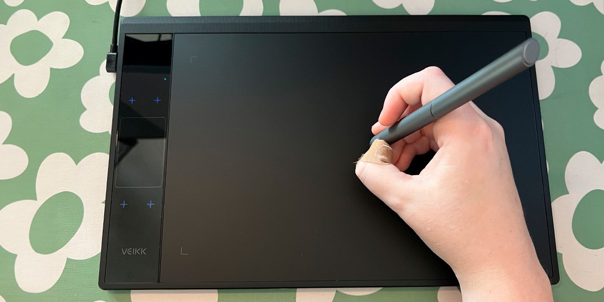 Hand using stylus on Veikk A30 V2 Drawing Tablet Hand using stylus on Veikk A30 V2 Drawing Tablet