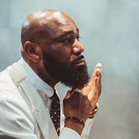 man grooming his beard