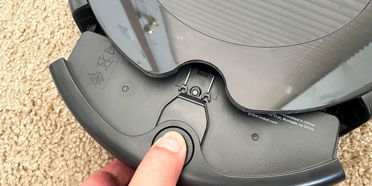 Person emptying Roomba's dustbin