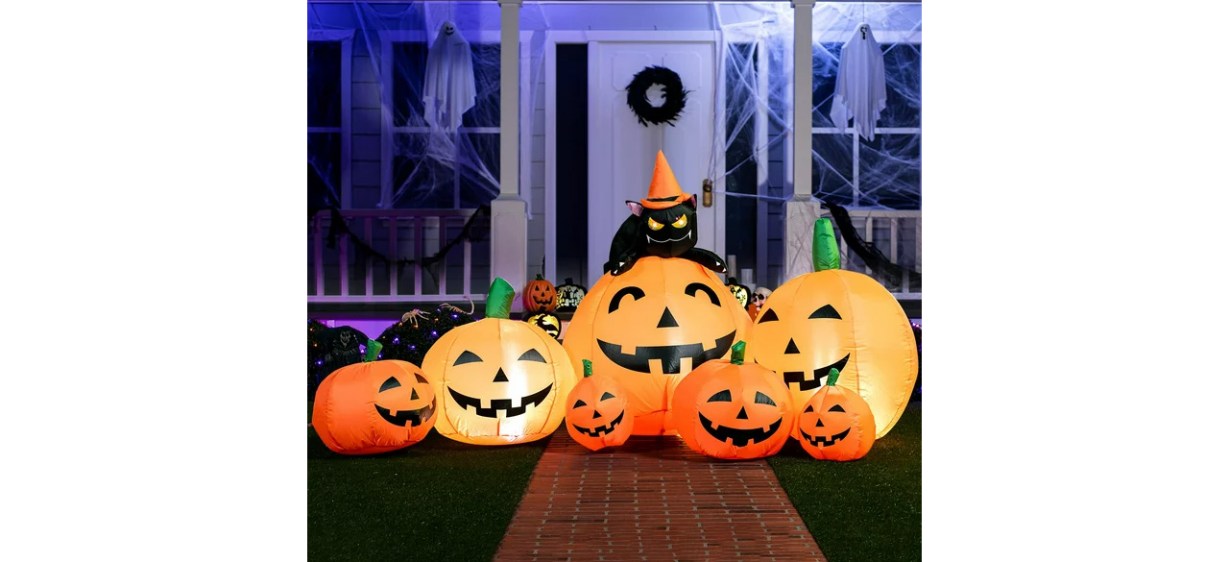 Halloween inflatable pumpkins in front yard at night Halloween inflatable pumpkins in front yard at night