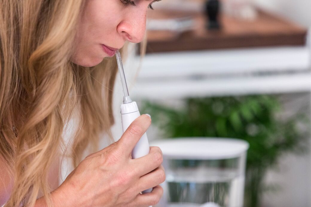 Cleaning teeth with water flosser